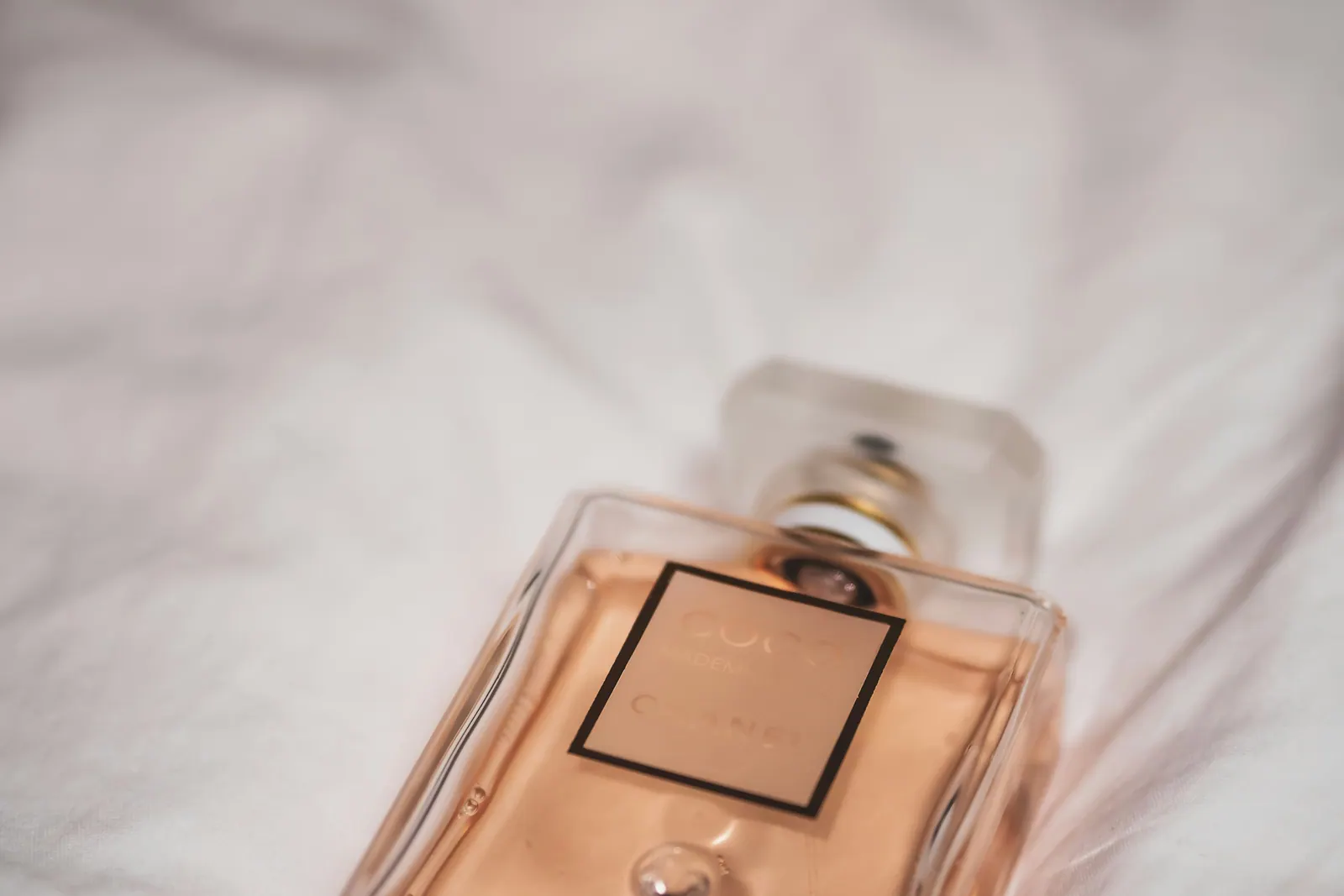 Close view of a flacon lying on soft sheets